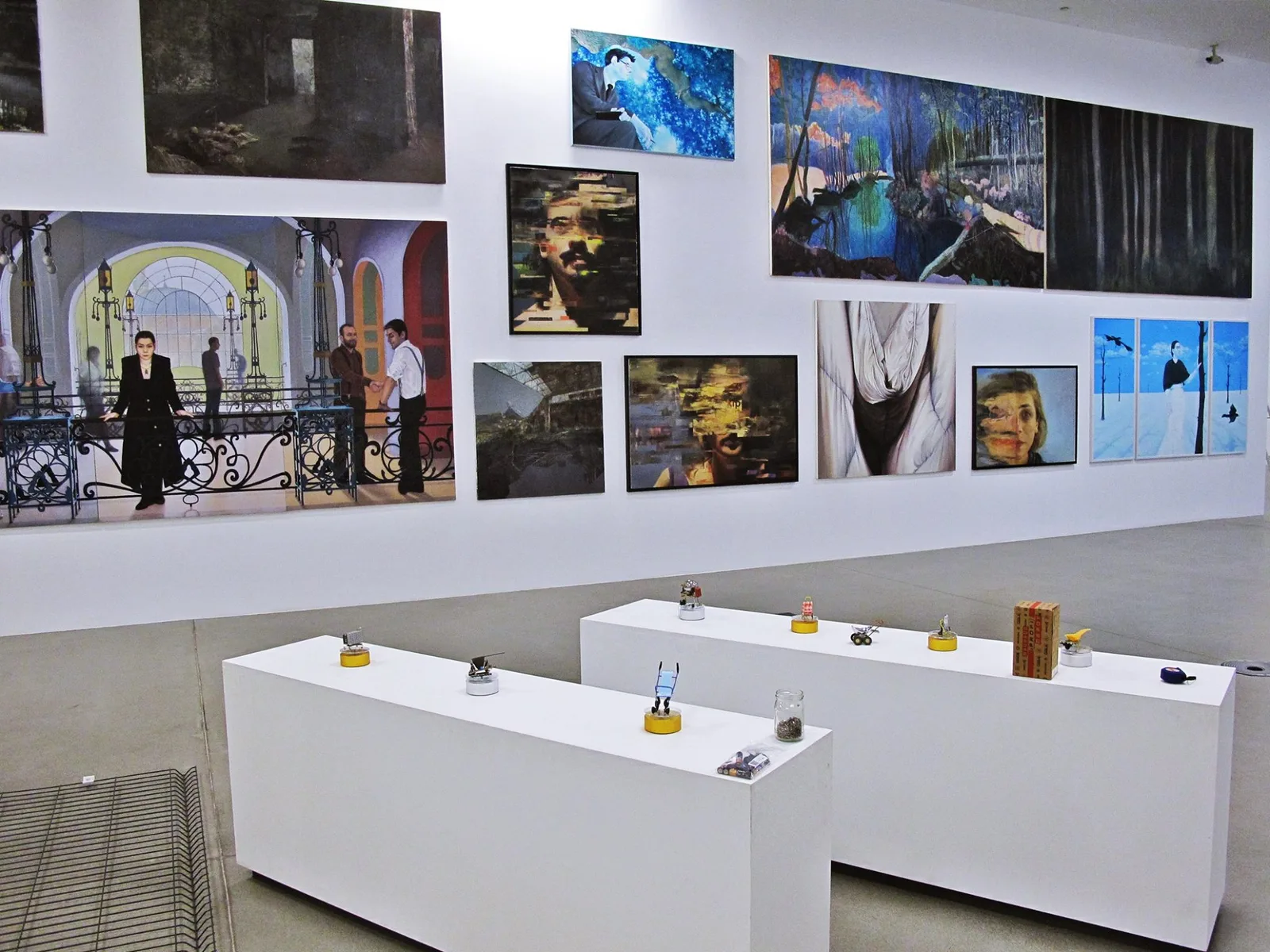 Installation view of a group exhibition wall with dozens of paintings and framed works hung together, illustrating how individual works begin to speak to one another once gathered into a shared archive